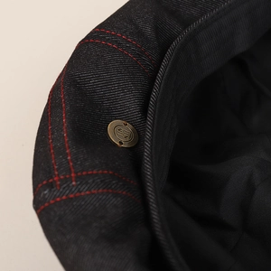 Classic black denim beret with vintage bronze button and red contrast stitching