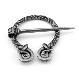 Close-up of vintage silver viking penannular brooch with twisted metal texture details