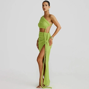 Detail of cut-out waist with knot tie on a grass green one-shoulder maxi dress