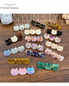 Flat lay of diverse acetate cat hair clips in tortoiseshell and glitter finishes