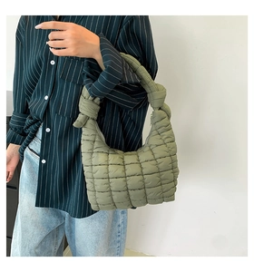 Detail of olive green quilted cloud bag featuring unique knotted handle design