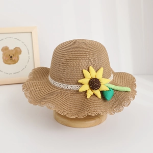 Detailed view of children's straw sun hat with cute sunflower and lace trim