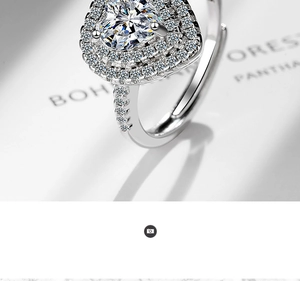 Macro shot of silver heart-shaped ring featuring double halo pave zircons and adjustable band