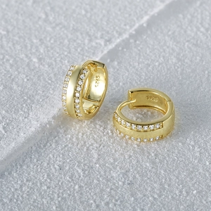 Macro shot of gold S925 sterling silver hoop earrings with double row zircon pavé