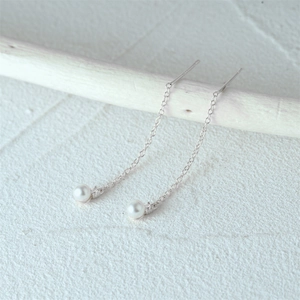 Detailed macro shot of S925 sterling silver pearl tassel earrings with zircon accents