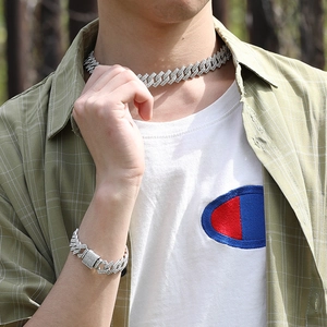 Gros plan d'un ensemble de collier et bracelet Cuban Link en argent avec cristaux micro-pavés