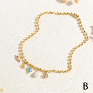 Golden bead chain necklace with fishtail, heart, blue gemstone and pearl pendants