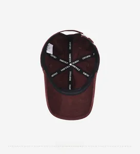 Detail of burgundy cotton baseball cap interior with reinforced tape and size label