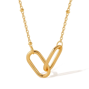 Detail of interlocking golden oval links on a fine bead chain necklace for women