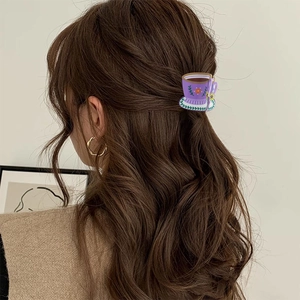 Creative coffee cup acrylic hair claw in purple and green on brunette wavy hair