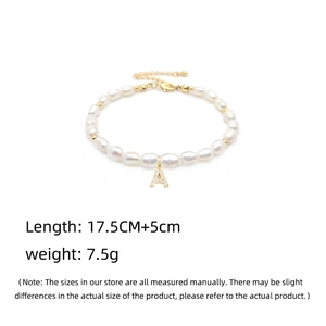 Detail showing freshwater pearl bracelet with a gold letter A rhinestone pendant charm