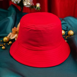 Classic red Christmas bucket hat with festive decorations and a premium holiday atmosphere