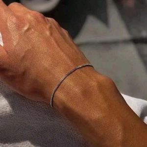 Minimalist silver metal chain bracelet for men and women shown on a model wrist