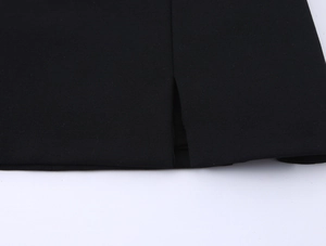 Detailed view of the side slit and high-quality stitching on a black sleeveless dress