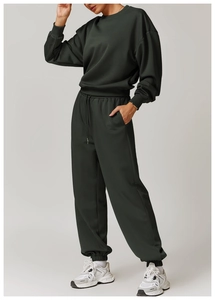Détail du sweat-shirt oversize vert foncé et du pantalon de jogging assorti à cordon