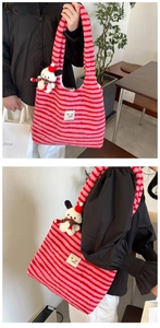 Detailed views of red and pink striped plush tote bag with a festive dog charm accessory