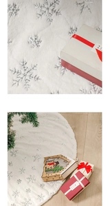 Detail of white faux fur Christmas tree skirt with shiny silver sequin snowflake patterns