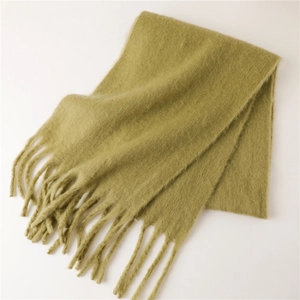 Gros plan d'une écharpe en mohair vert olive avec texture douce et longues franges