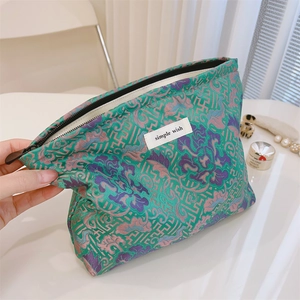 Macro shot of jacquard makeup bag with Chinese floral patterns and a simple wish label