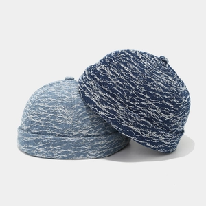 Close-up of vintage denim miki hats in dark and light blue with textured fabric detail