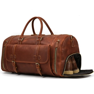 Detailed side view showing the dedicated shoe compartment in a vintage leather travel bag