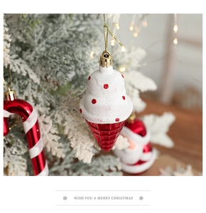 Macro view of glittery red and white ice cream ornament on a flocked Christmas tree