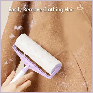 Purple lint roller removing white hair and dust from brown wool coat fabric surface