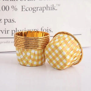 Macro detail of yellow checkered baking cups with premium gold foil lining texture