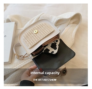 Detail view of woven straw saddle bag interior holding a smartphone and small wallet