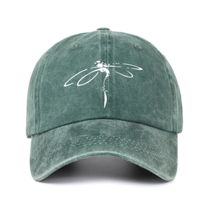 Detail of vintage washed green baseball cap with minimalist dragonfly print
