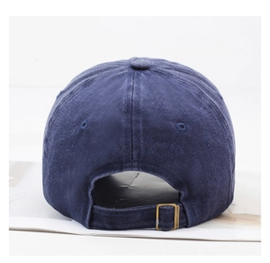 Detail of navy washed cotton baseball cap with adjustable bronze metal buckle back closure