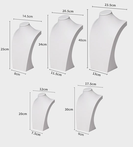 Detailed view of five white PU leather necklace display busts in various sizes