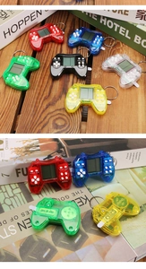 Mini retro handheld Tetris game console keychains in various colors on wooden surface