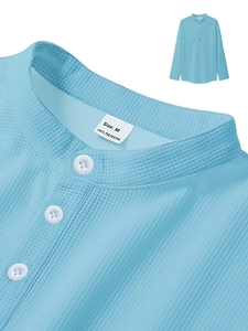 Detail of light blue waffle knit fabric and neckline labels on men's long sleeve polo