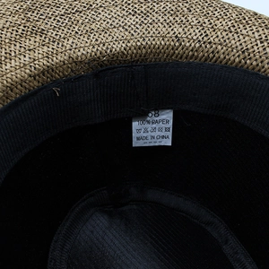 Detail of western straw cowboy hat interior with 100% paper material label and size 58 tag