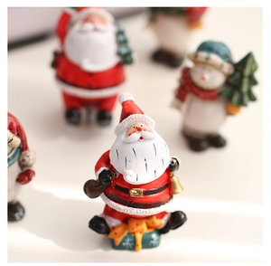 Detailed view of hand-painted resin Santa and snowman miniatures for Christmas decor