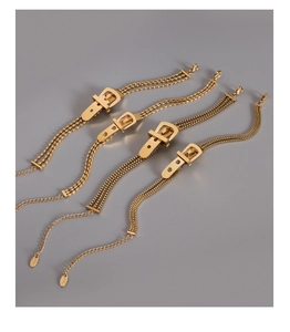 Detail of four 18K gold plated steel bracelets with unique belt buckle charms and chains