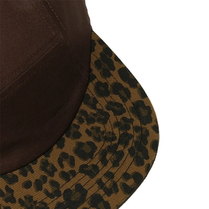 Macro detail showing leopard print pattern on the brim of a vintage brown baseball cap
