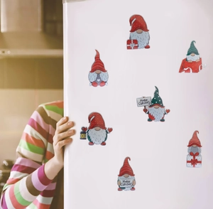 Diamond painting Christmas gnome stickers applied on a white refrigerator for holiday decor