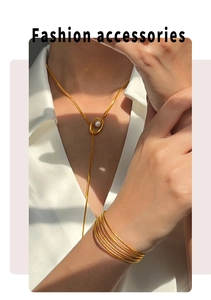 Fashionable gold necklace with pearl pendant and multi-layer stackable gold bracelets on model
