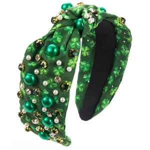 Close-up of St. Patrick's Day headband with green shamrocks, pearls, and rhinestones
