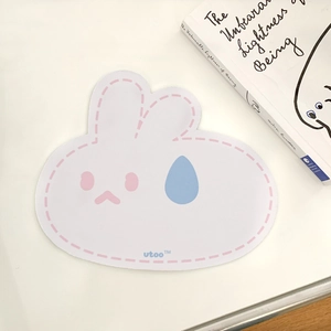 Cute cartoon rabbit shaped mouse pad with minimalist design on clean white desk