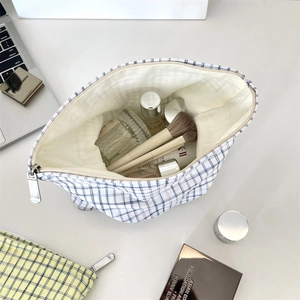 Internal view of large capacity plaid cosmetic bag storing premium skincare bottles