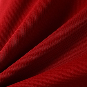 Macro shot of dark red textured knit fabric showing thickness and high-quality material
