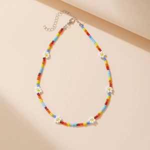 Close-up of handmade bohemian bead choker featuring colorful daisy flower patterns