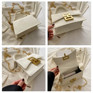 Detail of white suede square bag with golden chain and geometric double ring clasp