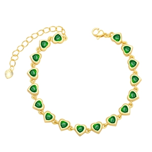 Detail of gold heart bracelet with green zircons, extension chain and lobster clasp
