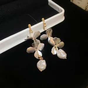 Silver needle long petal earrings with irregular pearl fringe on black velvet