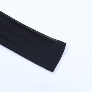 Detailed close-up of semi-transparent black lace mesh fabric with fine double stitching