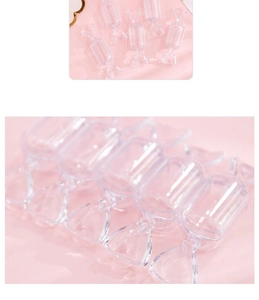 Macro shot of candy-shaped transparent plastic storage boxes on a pink background
